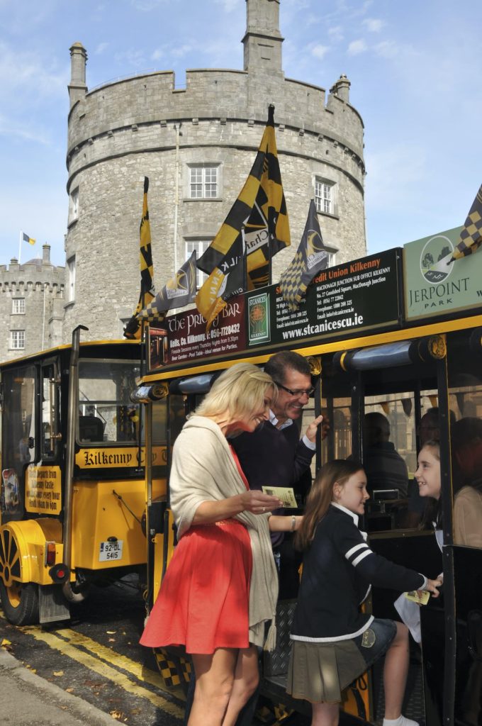 Guests enjoy a charming tram tour at Kilkenny Castle, showcasing historic architecture and friendly, informative guides.