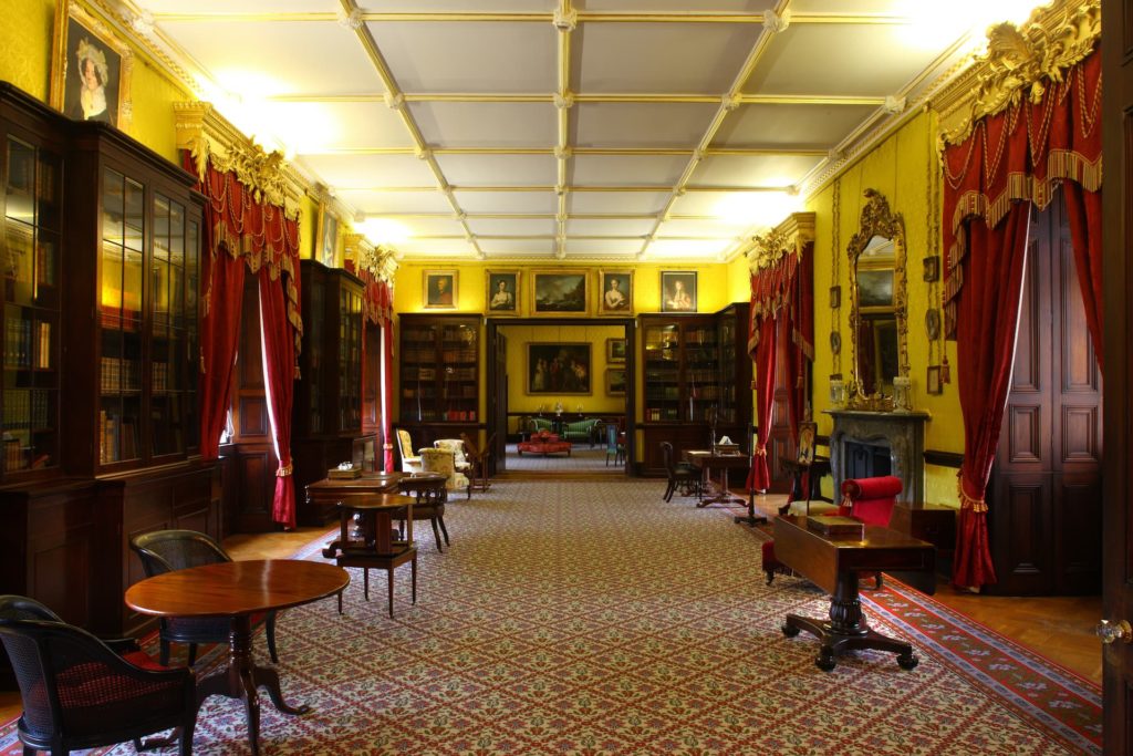 Elegant hotel library with opulent decor, cosy seating, and historic charm for guests to relax and unwind.