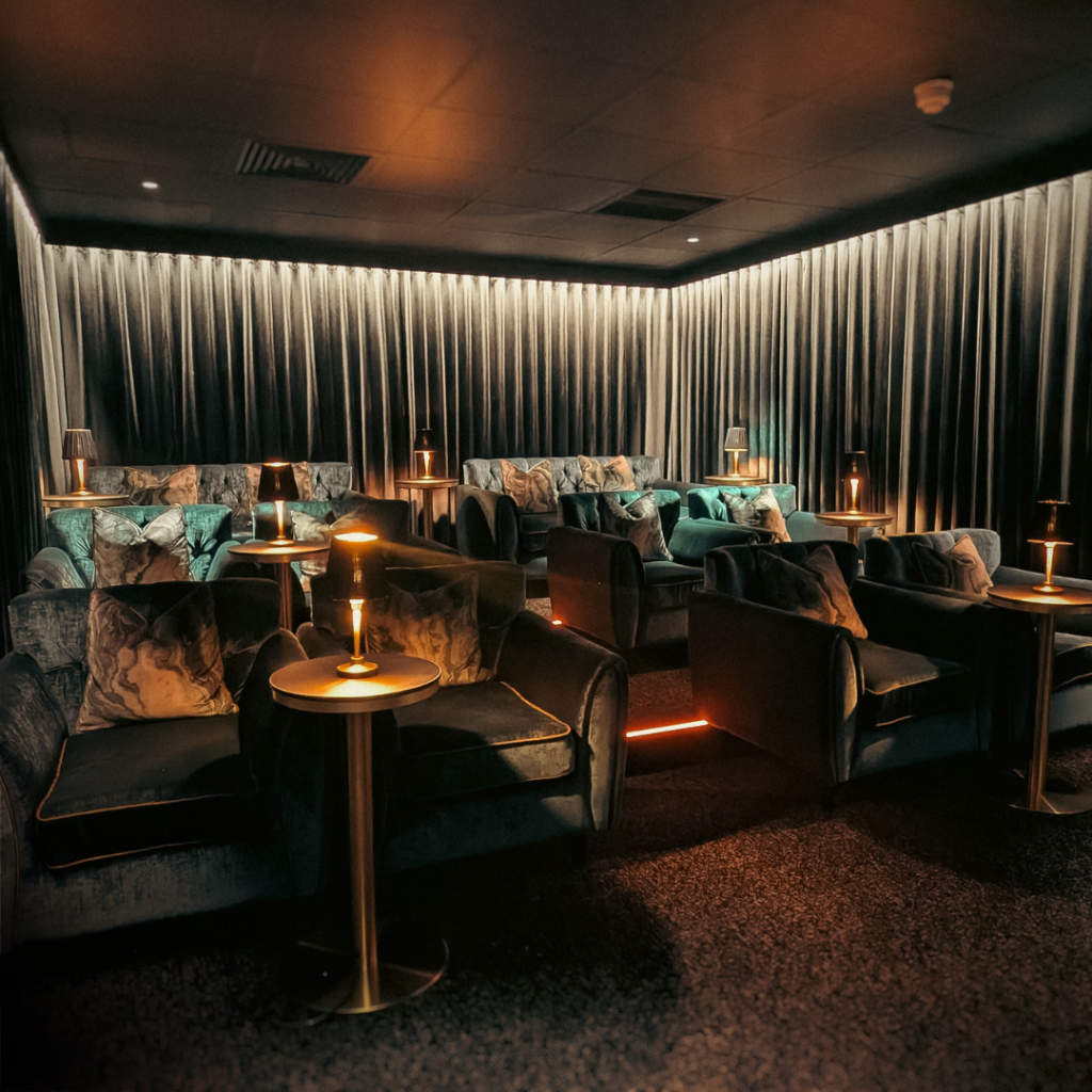 Luxurious Hotel Cinema Lounge Luxurious hotel cinema lounge with plush velvet seating, soft lighting, and cosy ambience for a relaxing movie experience.